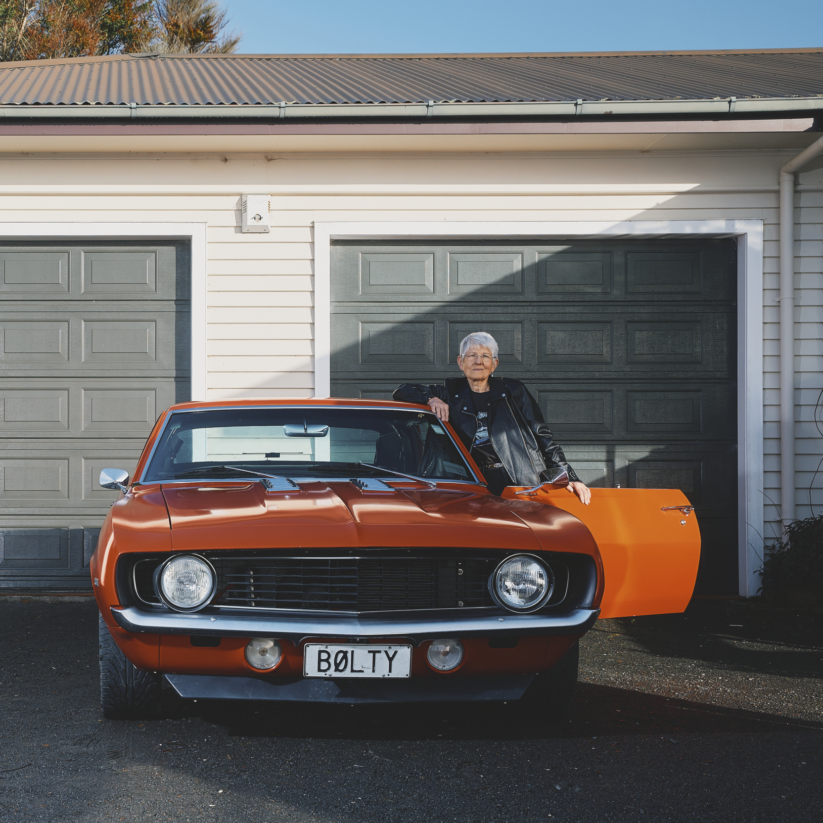 At 174 Older Woman With Orange Car